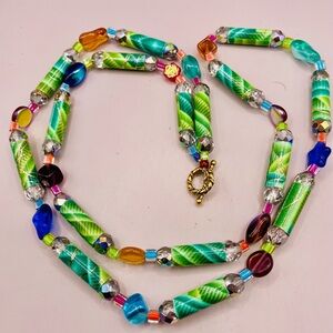 Long green leaf paper bead and multi color crystal bead necklace. 32 inches long